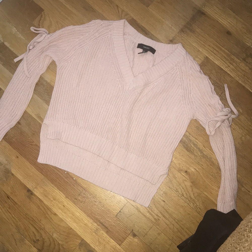 A PINK SWEATER V NECK WITH BOW TIES ON THE SLEEVES